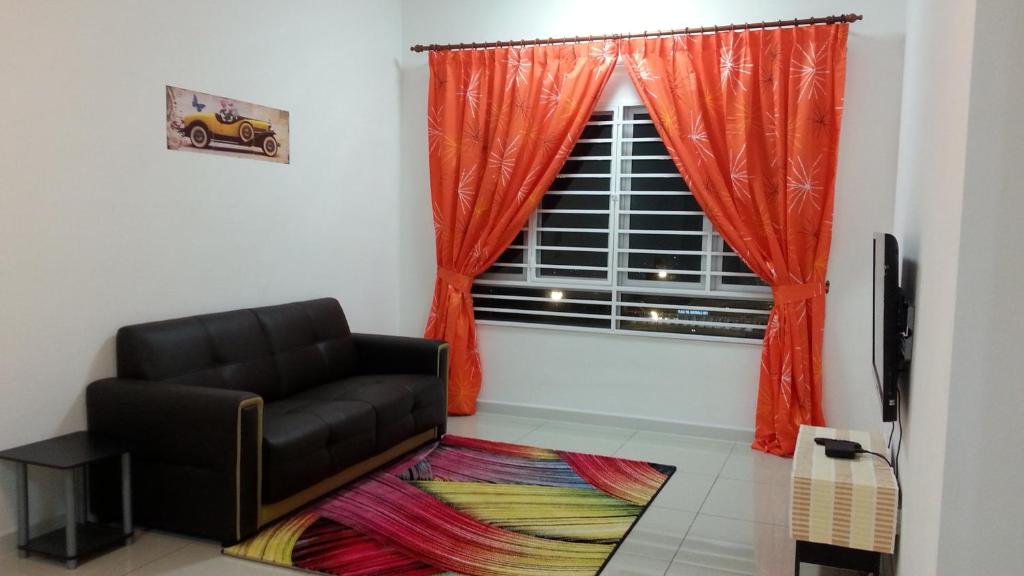 a living room with a chair and a window at AZ Homestay @ Southville City in Bangi