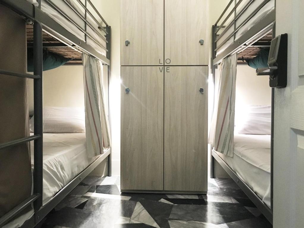 Postel nebo postele na pokoji v ubytování Tainan Gu Hostel