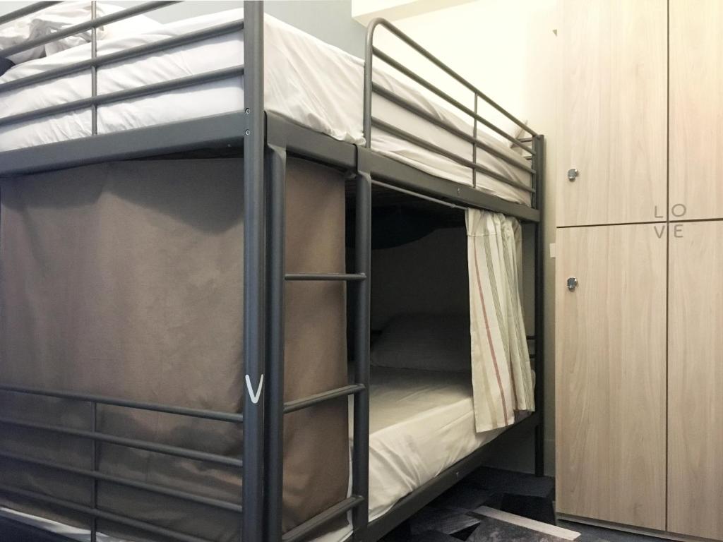 Postel nebo postele na pokoji v ubytování Tainan Gu Hostel