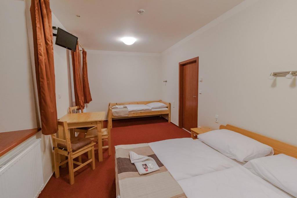 Postel nebo postele na pokoji v ubytování Penzion U řízků