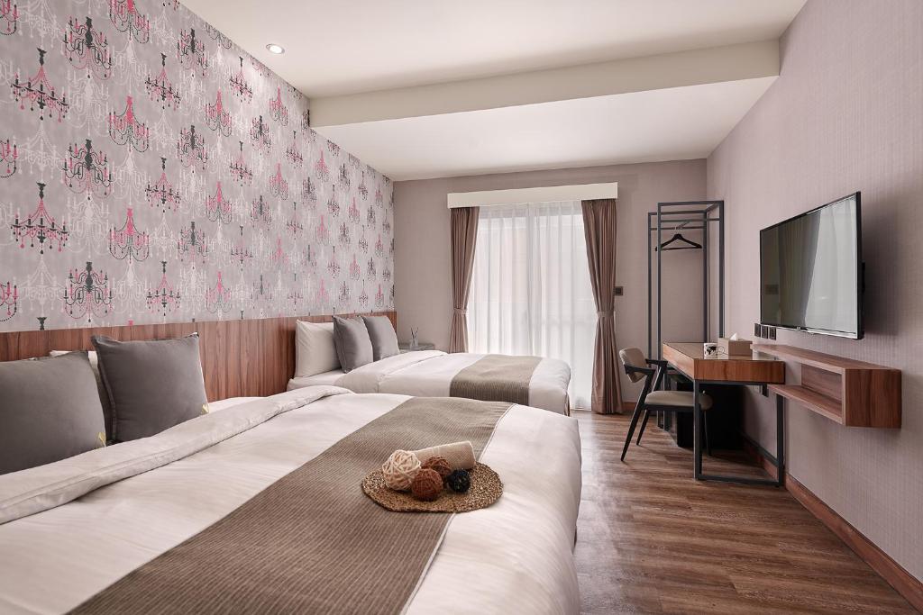 Postel nebo postele na pokoji v ubytování Muzik Hotel - Ximending Xining Branch