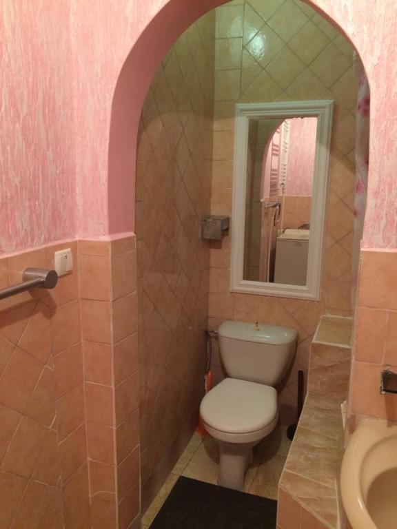 ein Bad mit einem WC und einem Spiegel in der Unterkunft Vasile Alecsandri 60 ap 49 in Chişinău