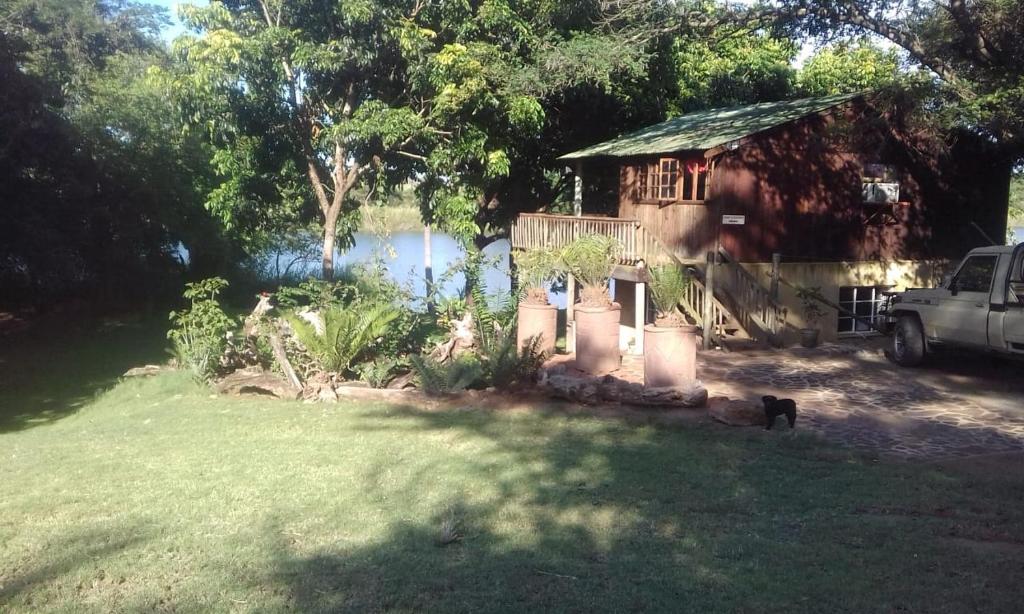 a house with a car parked in front of it at Hippo Retreat & Tiger Fishing Komatipoort in Komatipoort