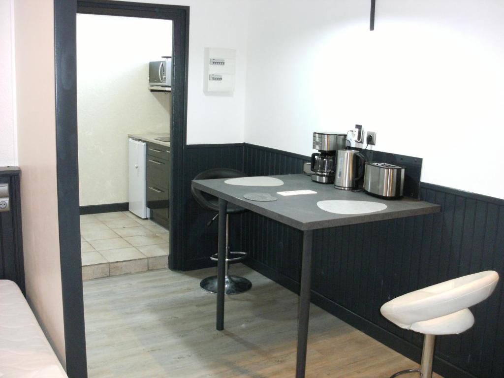 a bathroom with two sinks and a mirror at studio vic 2.0 in Vic-sur-Cère