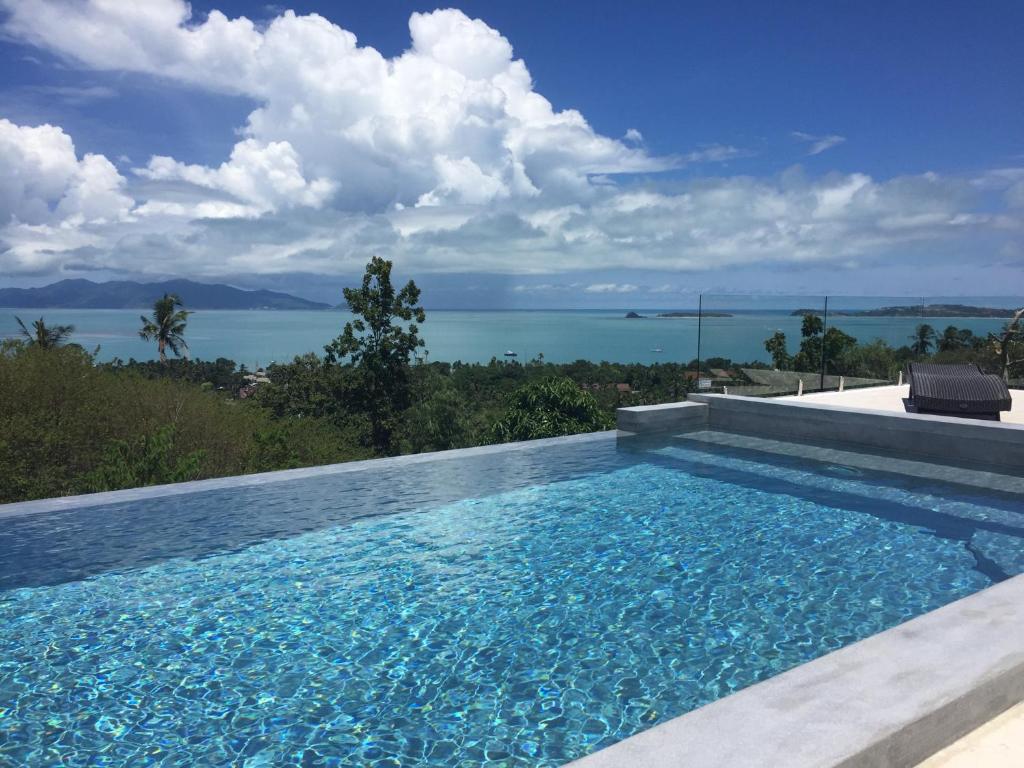 a swimming pool with a view of the water at VILLA ARGANDA Infinity Pool Luxury Sea View in Bophut