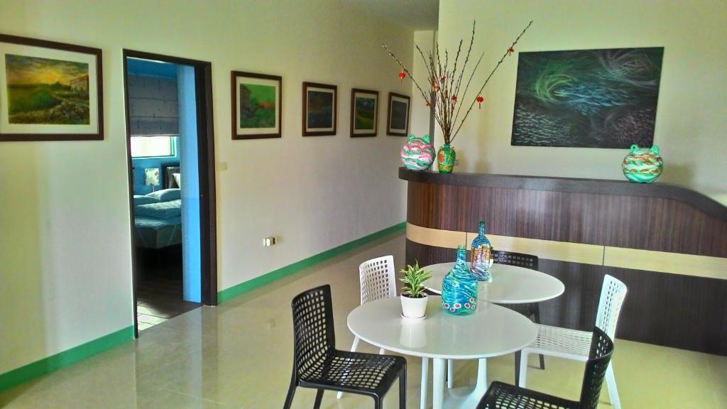 a dining room with a table and chairs and a room at Dreamily Fish B&amp;B in Magong