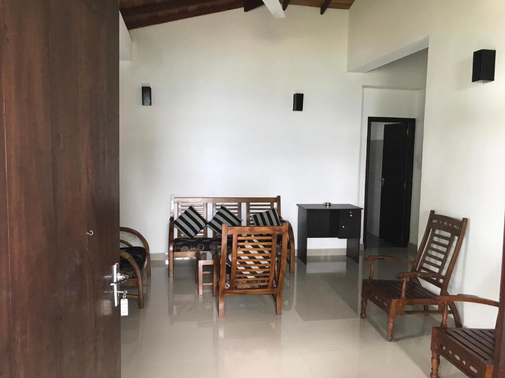 a group of chairs and a table in a room at Unawatuna Beach Bungalow - in Unawatuna