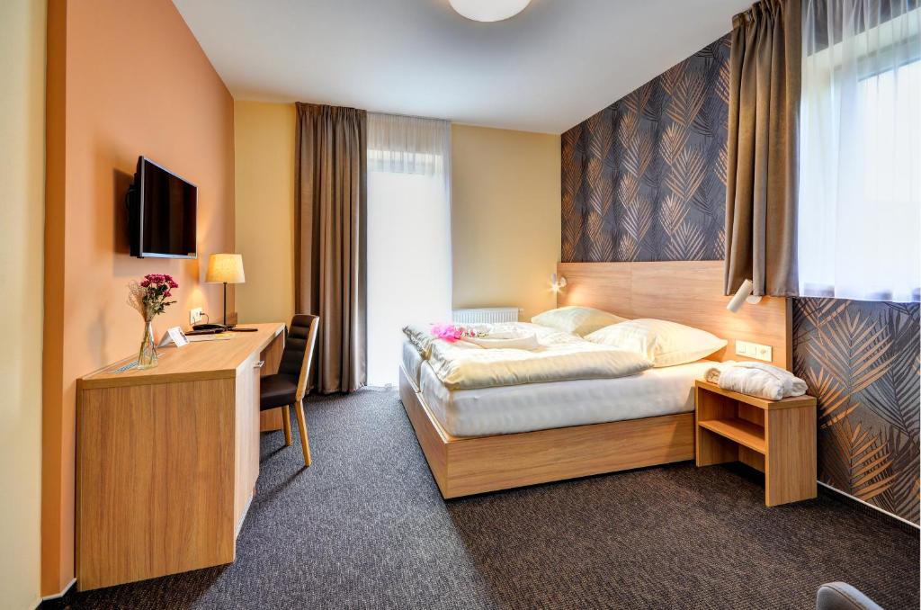 Postel nebo postele na pokoji v ubytování Hotel Helios