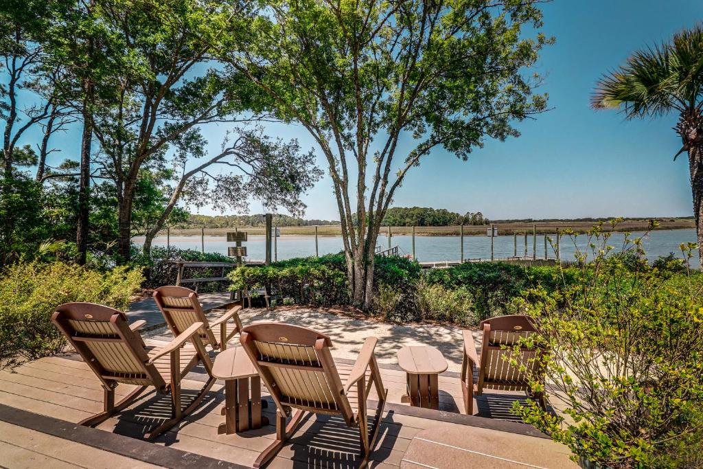 a row of chairs and tables with a view of the water at Inlet Cove 12 in Kiawah Island