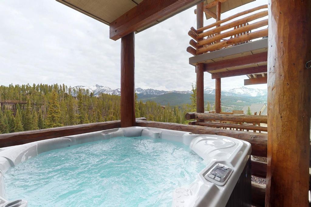 a hot tub on the deck of a cabin at Saddle Ridge B2 in Big Sky