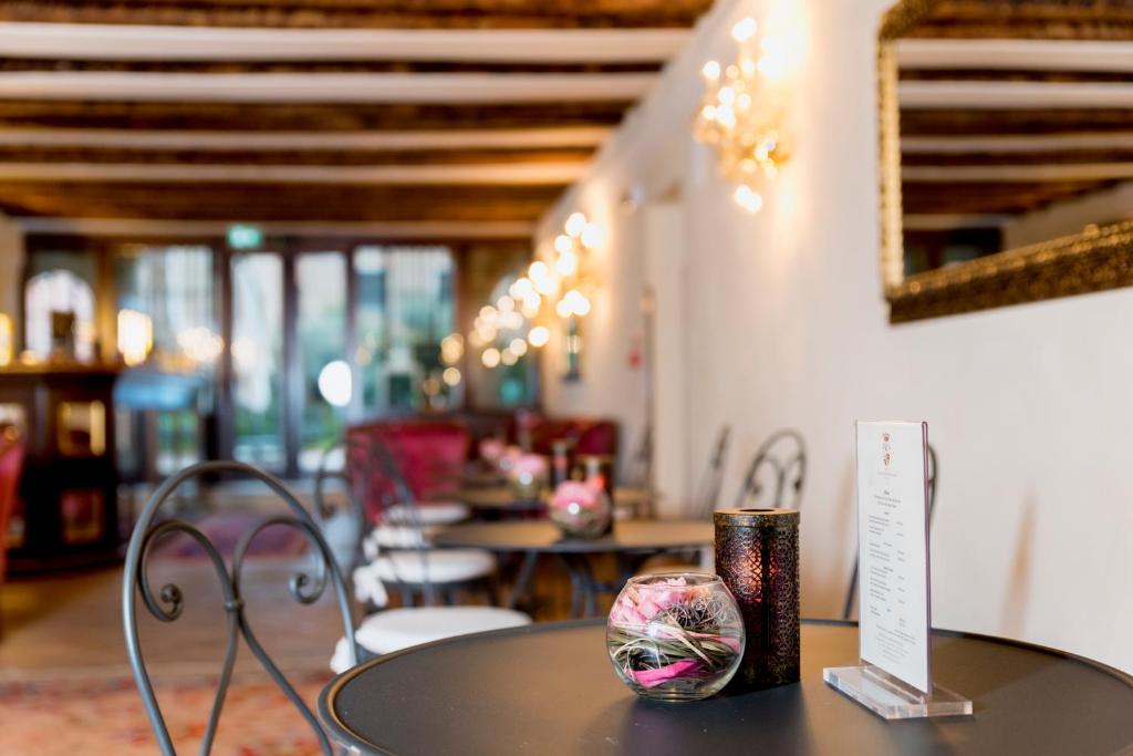 a table in a room with tables and chairs at Hotel Nani Mocenigo Palace in Venice