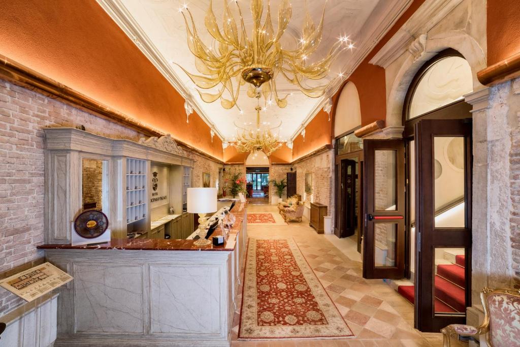 a hallway of a building with a chandelier at Hotel Nani Mocenigo Palace in Venice
