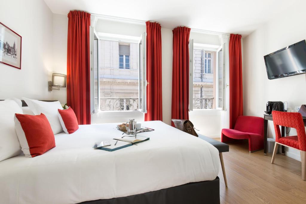 圖盧茲的住宿－阿爾伯特第一酒店，酒店客房设有一张大床和红色窗帘