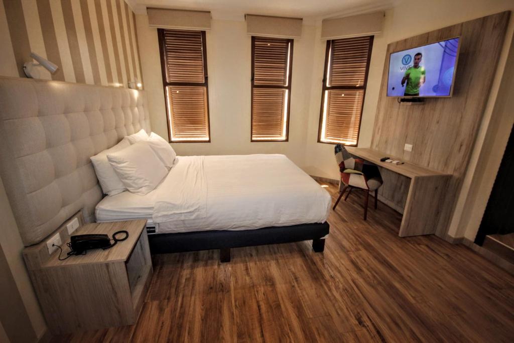 TV a/nebo společenská místnost v ubytování Cedros Inn Boutique Hotel