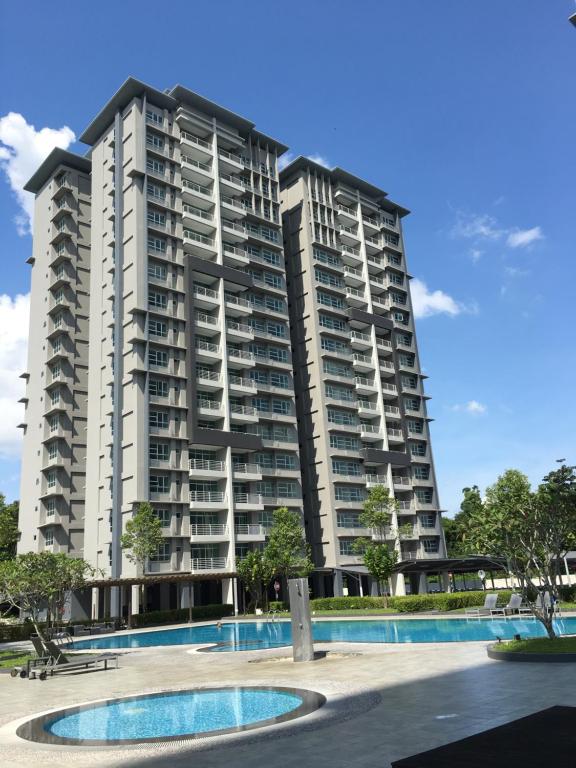 a large apartment building with a pool in front of it at OHANA Sky Villa Residences in Kuching