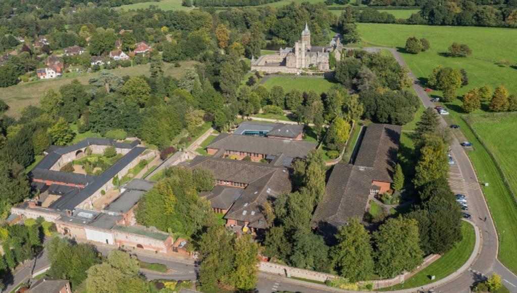 an aerial view of an estate with a building at De Vere Horsley Estate in Leatherhead