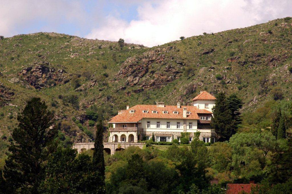 a large house on the side of a mountain at El Castillo de Mandl in La Cumbre