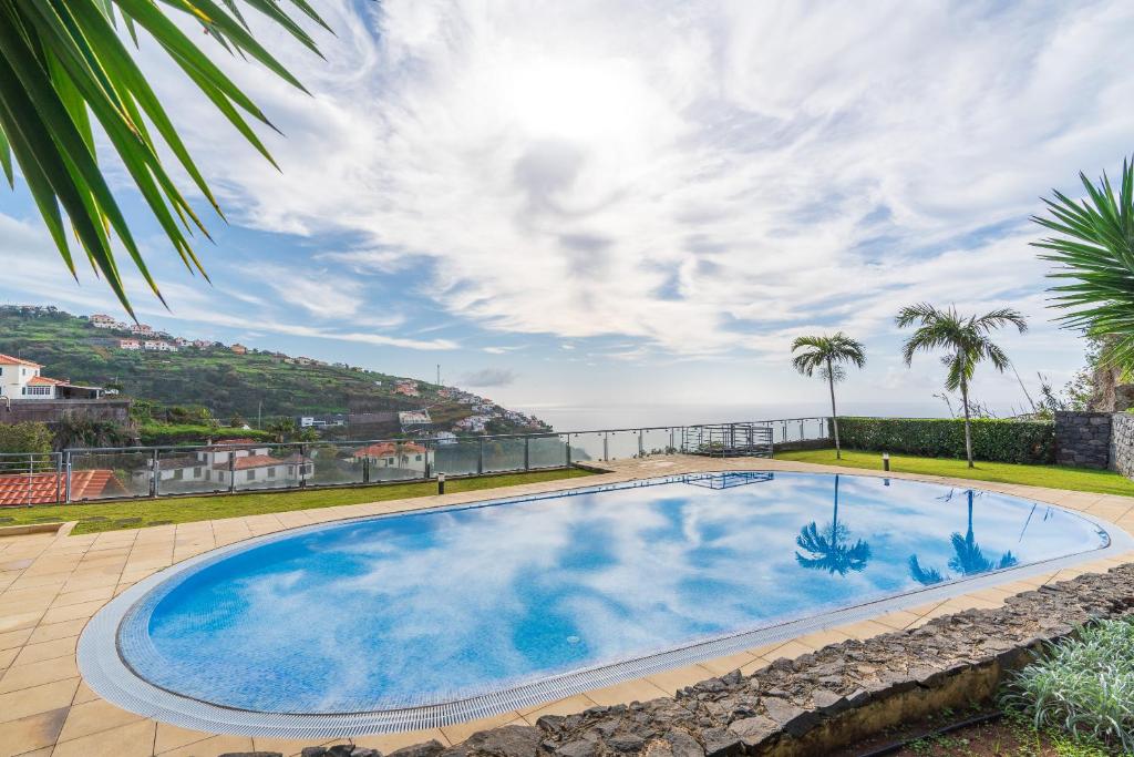 una grande piscina con vista sull'oceano di Apartamento Serramar , Vistas deslumbrantes a Calheta