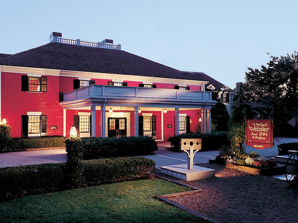 a red house with a sign in front of it at Dan'l Webster Inn and Spa in Sandwich