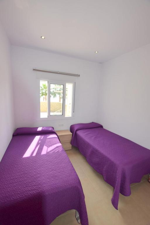 Posteľ alebo postele v izbe v ubytovaní Carihuela 1ª Línea de playa - Casa Abuela María