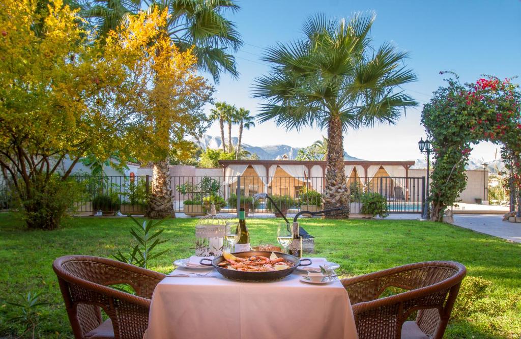 a table with a bowl of food on top of a yard at Hotel Tossal d'Altea in Altea