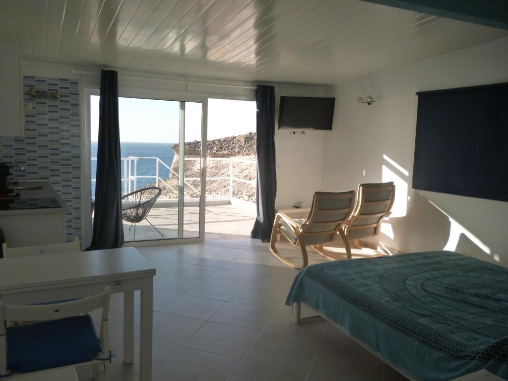 a bedroom with a bed and a view of the ocean at Roca Mar Tenerife in La Mareta