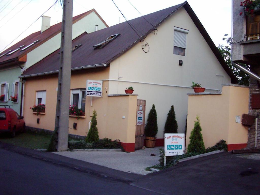 a house with signs in front of it at Vass Vendégház in Eger