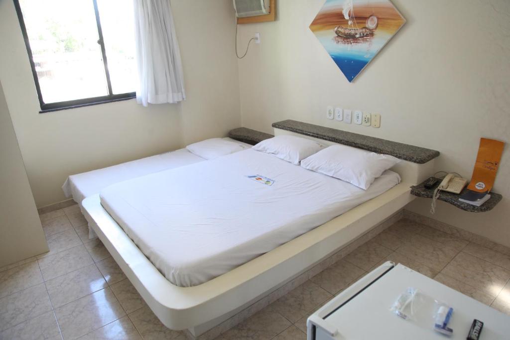 Postel nebo postele na pokoji v ubytování Hotel Piramide Pituba - Av Paulo VI