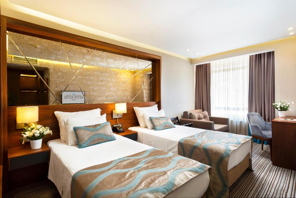 Postel nebo postele na pokoji v ubytování Artur Hotel