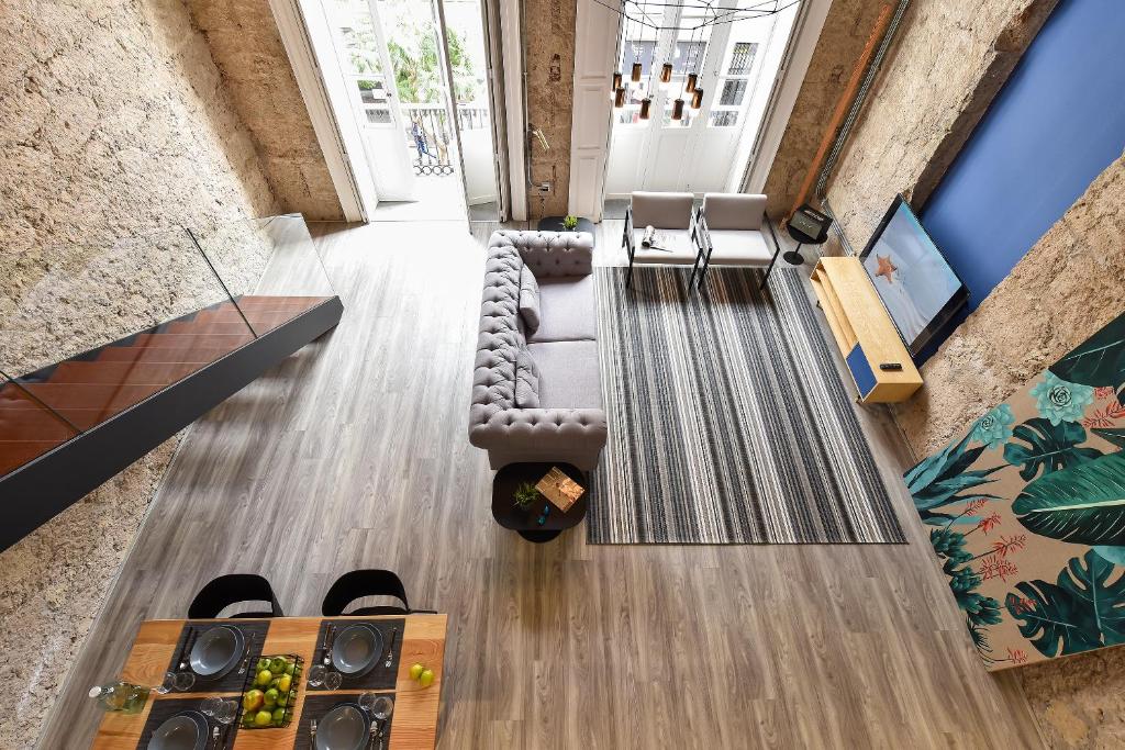 an overhead view of a living room with a couch and chairs at OFF TRIANA in Las Palmas de Gran Canaria