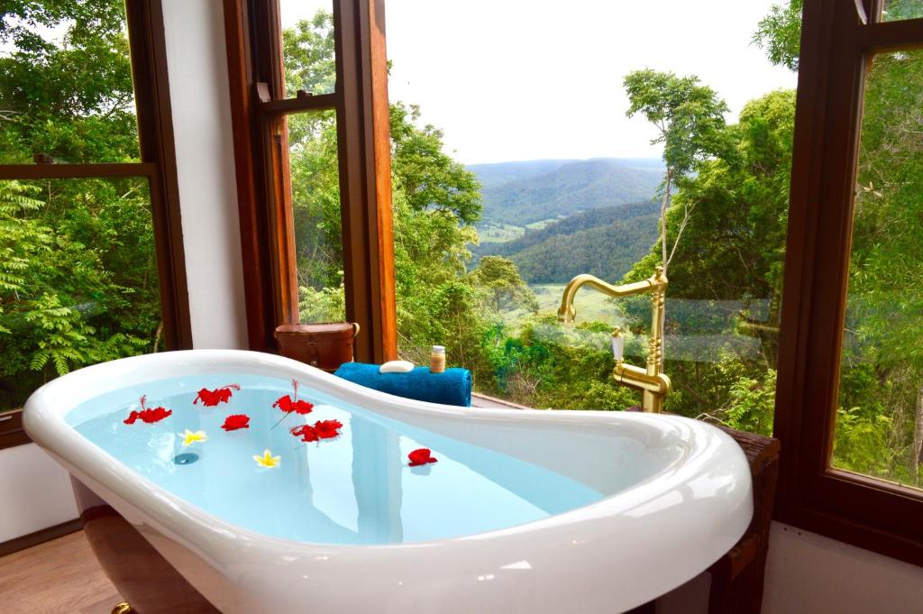 a bath tub in a room with a window at Clouds Serenity in Beechmont