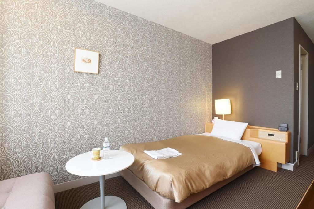 Letto o letti in una camera di Hotel Grand Vert Gizan