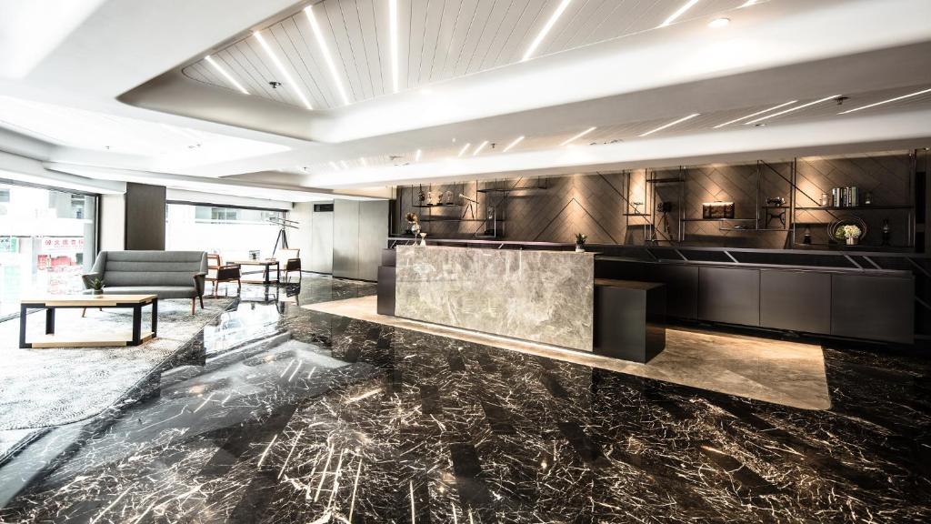 a large kitchen with a marble counter top in a room at Hotel Ease Tsuen Wan in Hong Kong