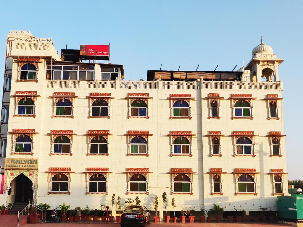 a large white building with a dome on top of it at Kalyan Heritage in Jaipur