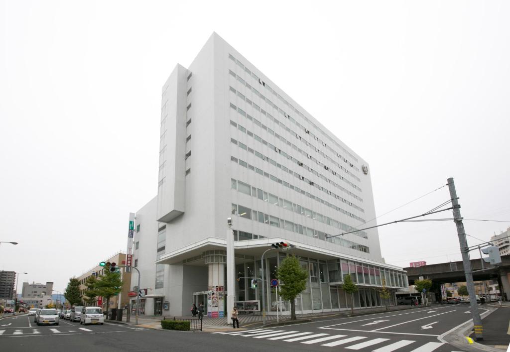 a white building on the corner of a street at Tottori Washington Hotel Plaza in Tottori