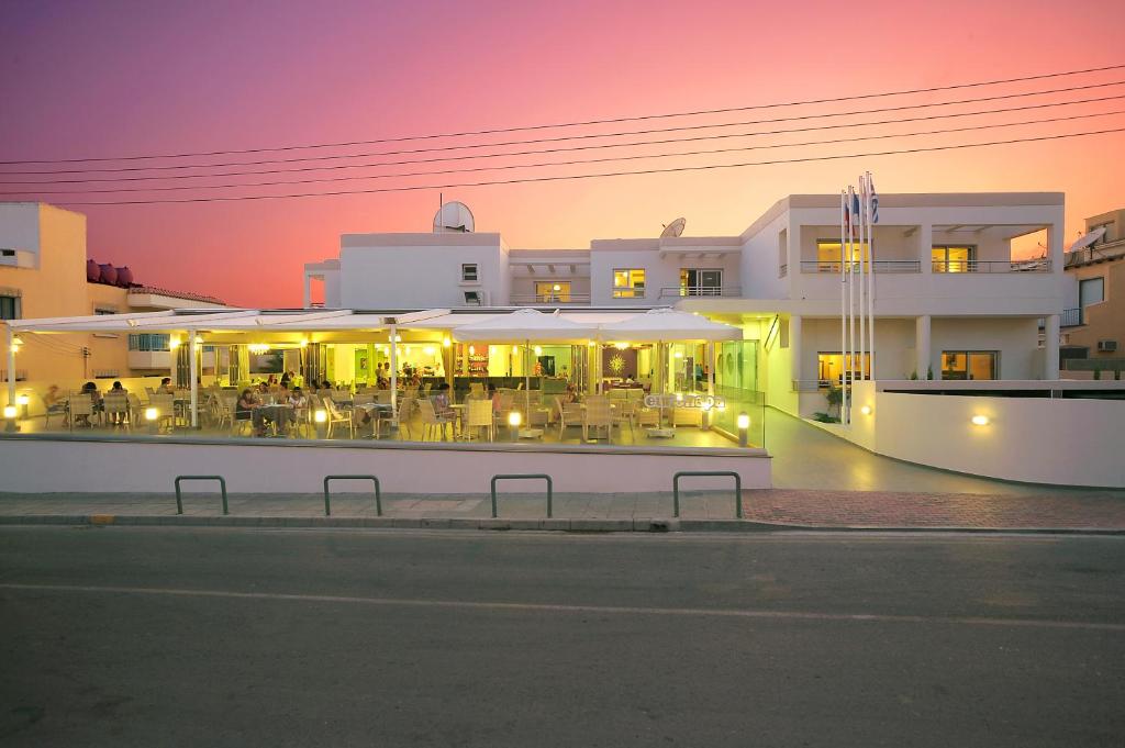 a building with a restaurant with tables and chairs at night at Euronapa Hotel Apartments in Ayia Napa