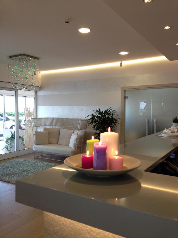 a living room with a table with candles on it at Hotel Lux in Caorle
