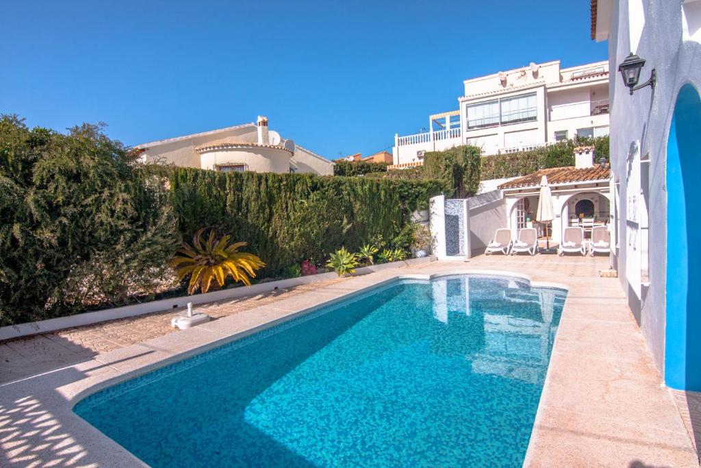 a swimming pool in the backyard of a house at Villas Guzman - Belvic in Calpe