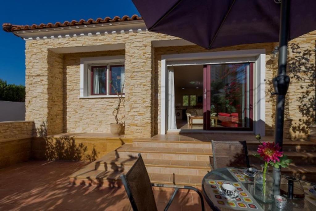 a patio with a table and an umbrella at Villas Guzman - Chirla in Calpe