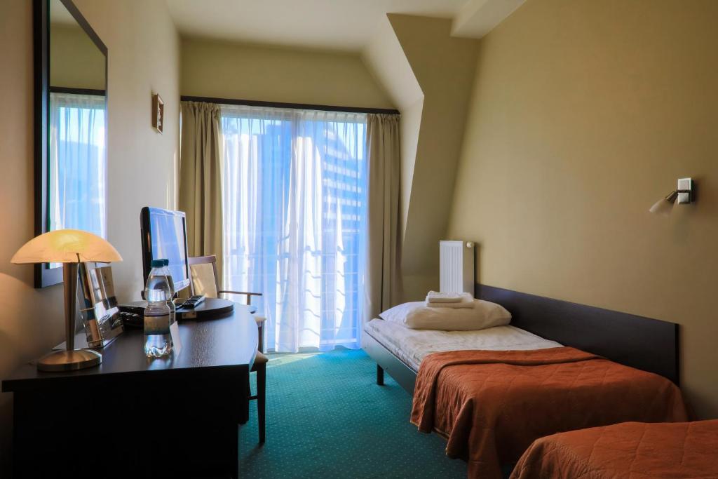 Postel nebo postele na pokoji v ubytování Hotel *** NAT Ustroń
