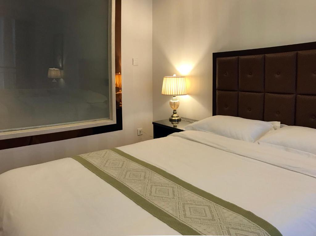 Postel nebo postele na pokoji v ubytování Qingdao Elegant Central Apartment