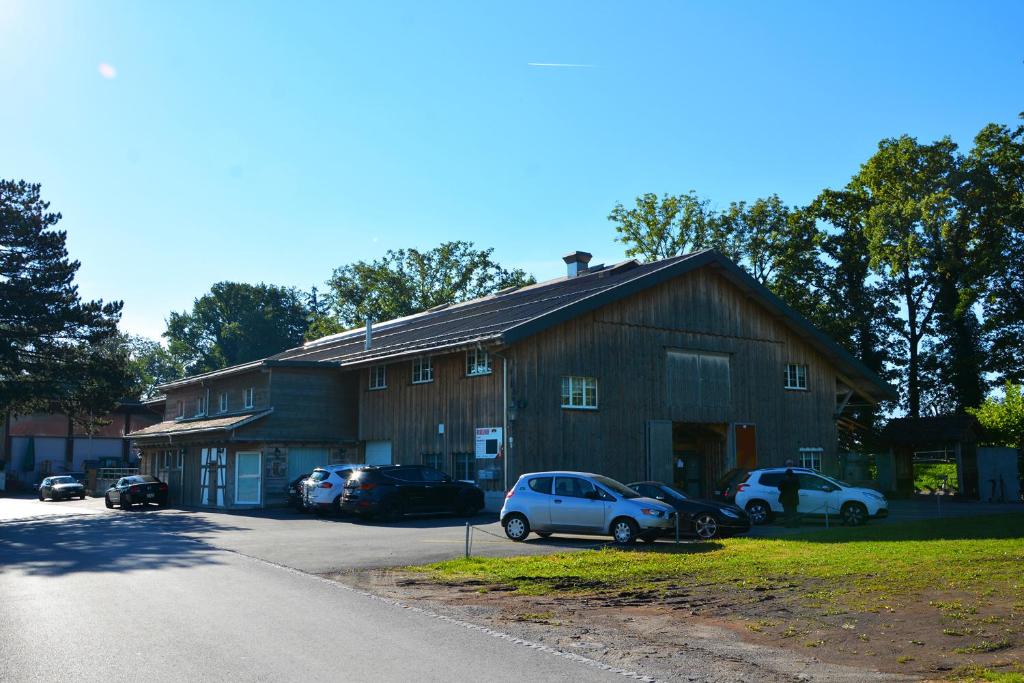 a barn with cars parked in front of it at Ribelhof in Altstätten