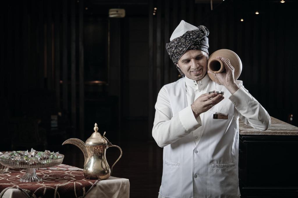 a chef is standing in front of a table at Dallah Taibah Hotel in Medina