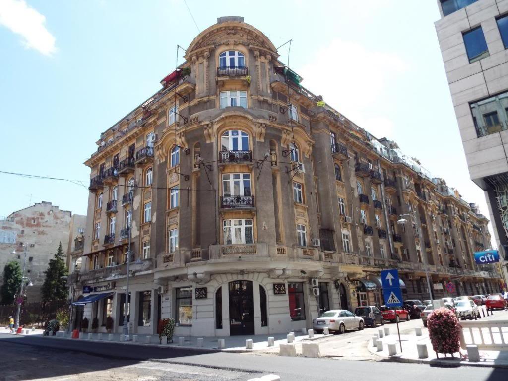 a large building on the corner of a street at VICTORIA LUXURY APARTMENT in Bucharest