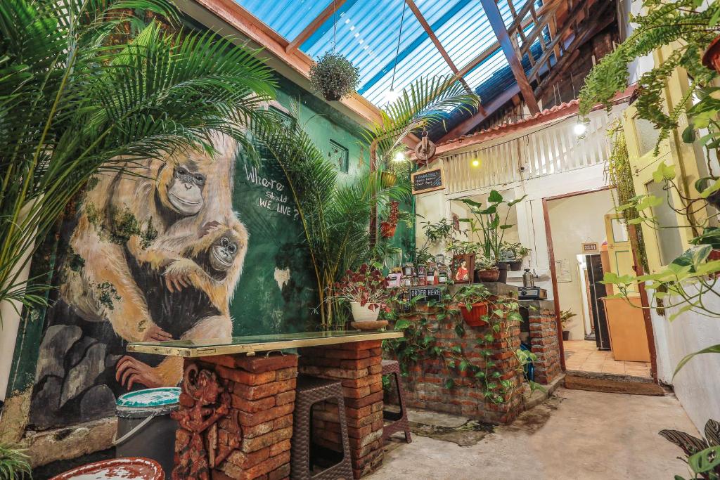 a room with a large painting of a monkey on the wall at Snooze in Yogyakarta