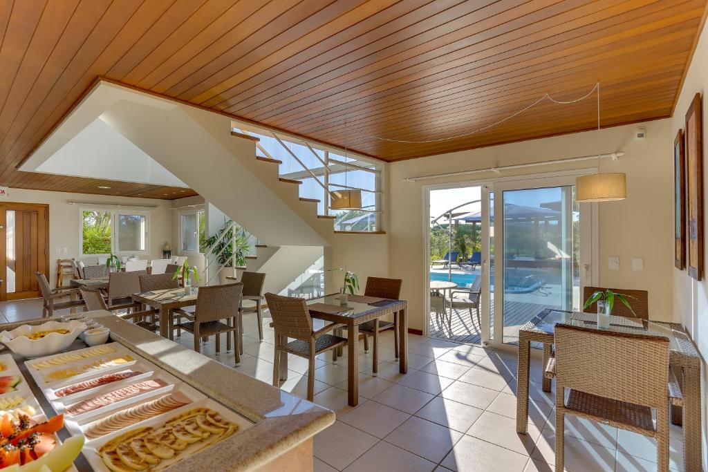 an open dining room with a table and chairs at Pousada Ilha Faceira in Florianópolis