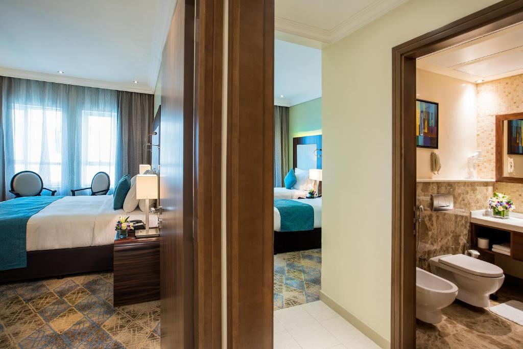 Postel nebo postele na pokoji v ubytování Elite Byblos Hotel