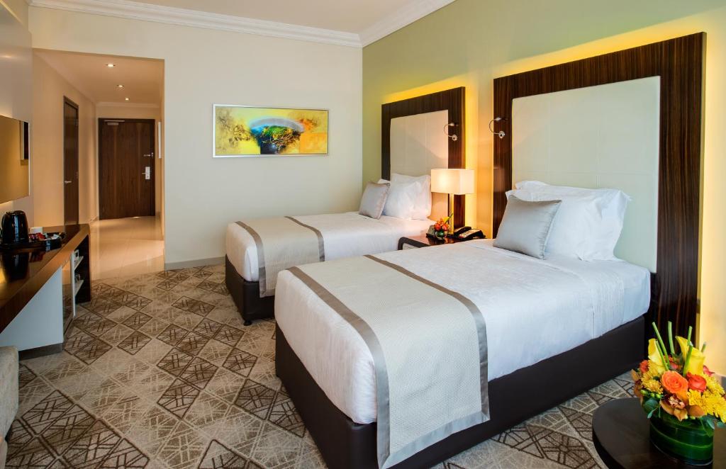 Postel nebo postele na pokoji v ubytování Elite Byblos Hotel