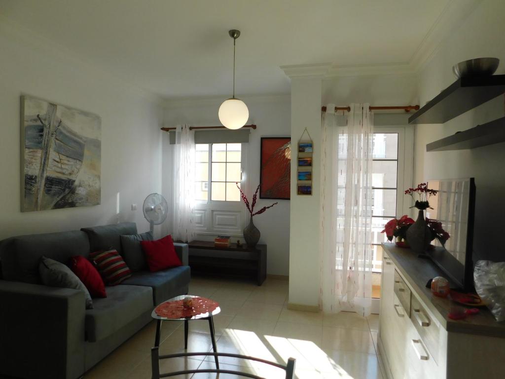 a living room with a couch and a table at Sol de Tenerife in Los Abrigos