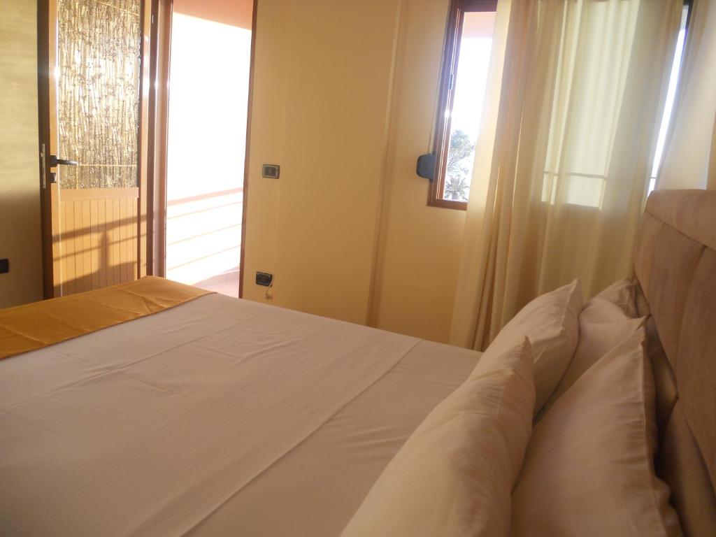 Postel nebo postele na pokoji v ubytování Onorato Hotel